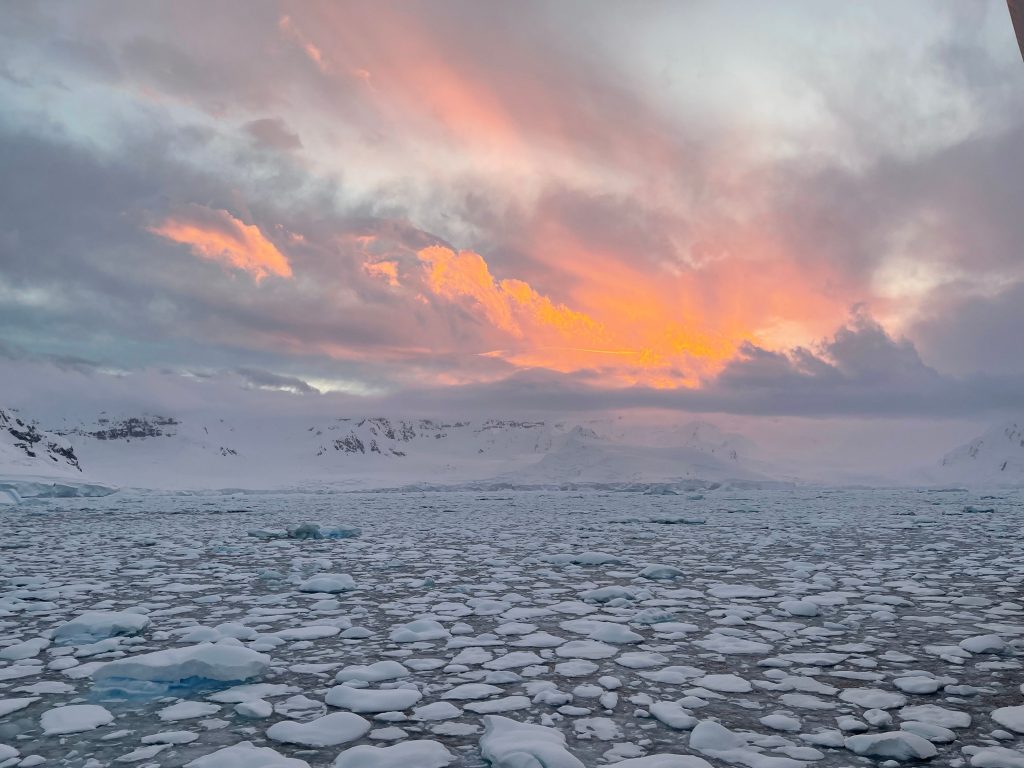 The Antarctic sun sets over the mountains