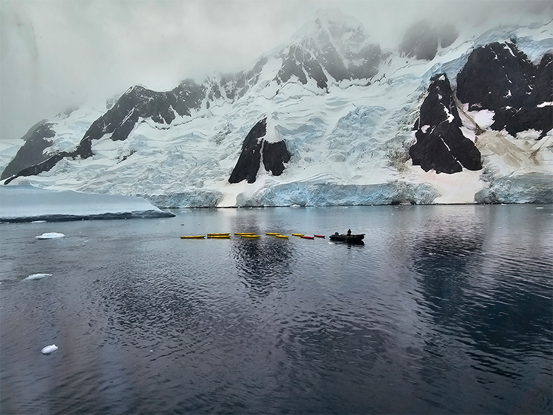 Kayaks floating neat the icebergs
